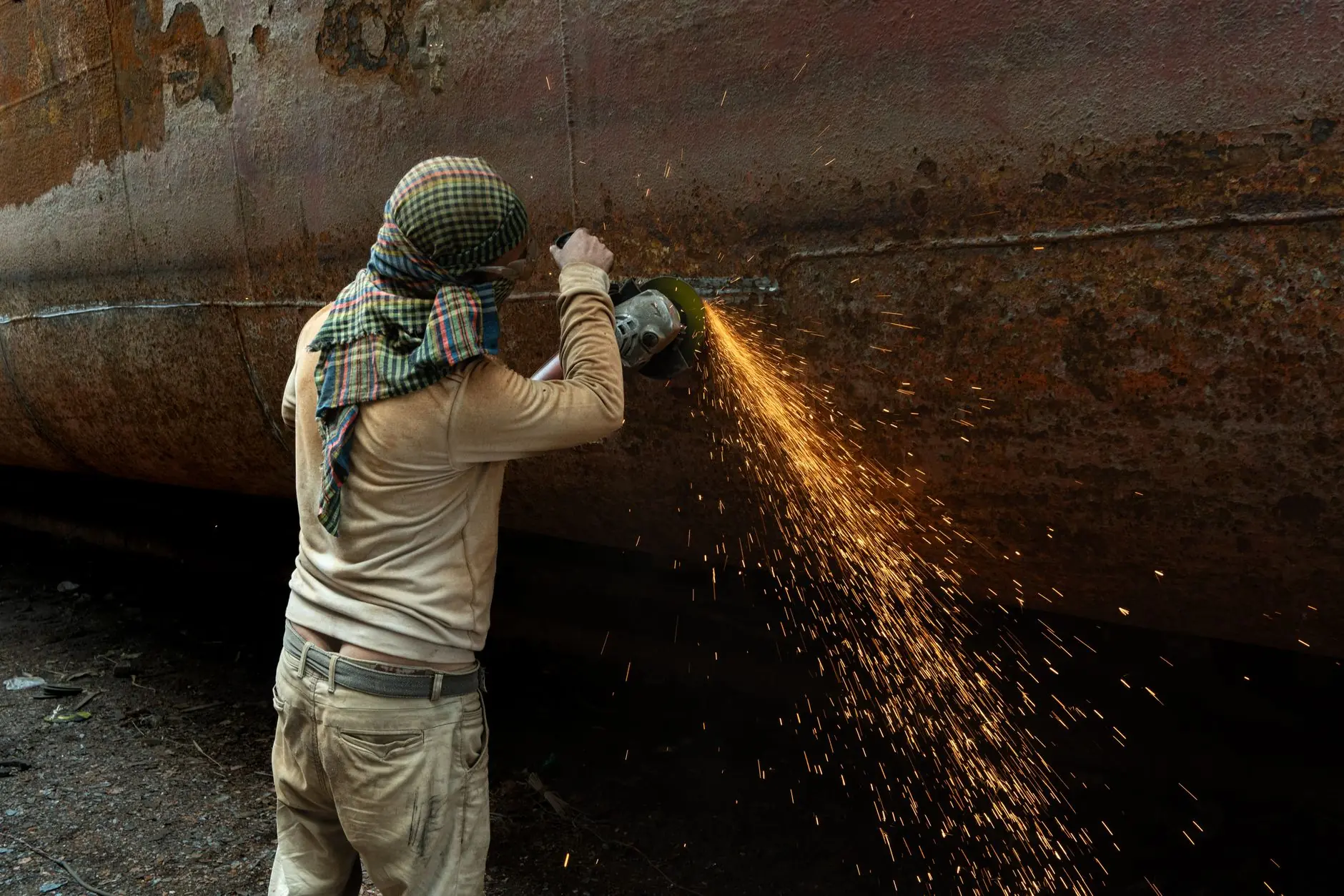 Welder cutting steel with sparks flying